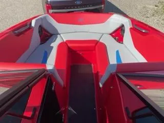 Slide: The Image of 2023 MasterCraft NXT 22 boat interior with red and gray seating. - 10