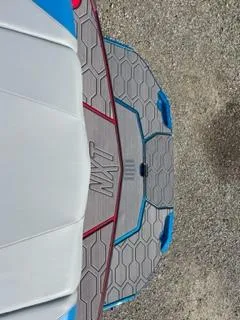 Slide: The Image of 2023 MasterCraft NXT 22 boat deck with hexagonal pattern and blue accents. - 3
