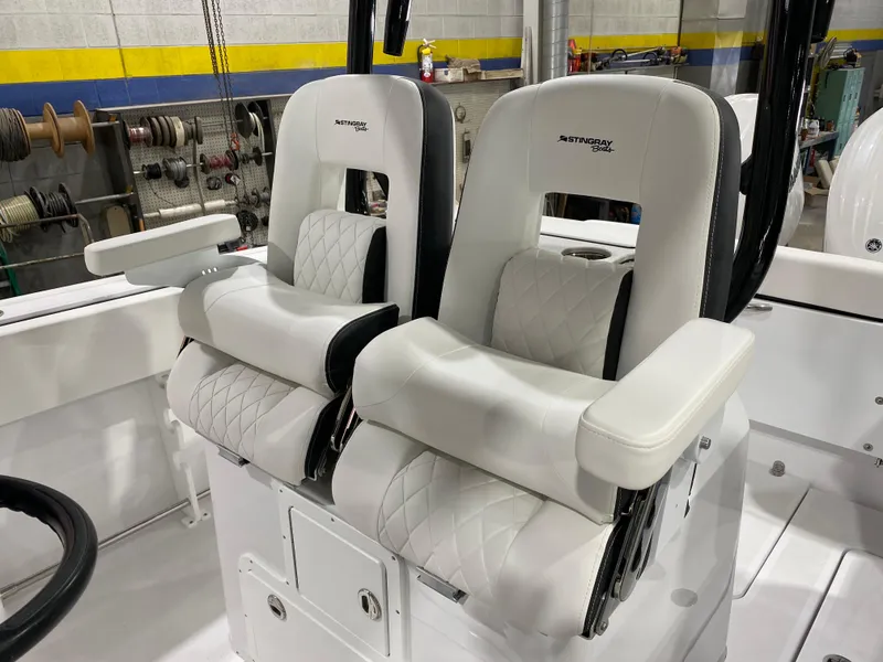 Slide: The Image of 2025 Stingray 253CC boat seats, white leather, modern design, in a workshop setting. - 10