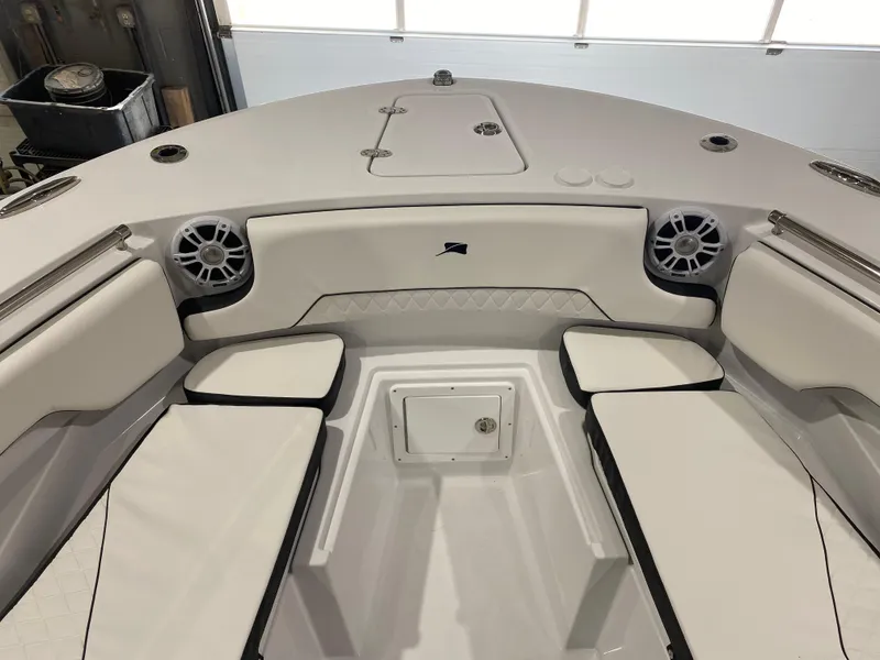 Slide: The Image of 2025 Stingray 253CC boat interior with cushioned seating and speakers. - 16