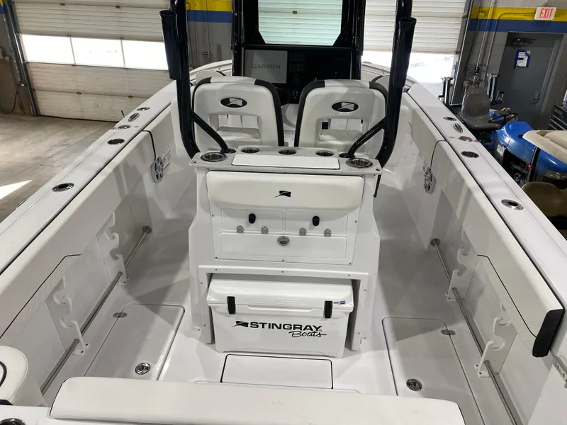 Slide: The Image of 2025 Stingray 253CC boat interior with dual seats and storage compartments. - 5