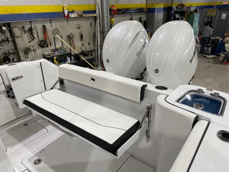 Slide: The Image of 2025 Stingray 253CC boat interior with dual Yamaha engines in a workshop. - 6