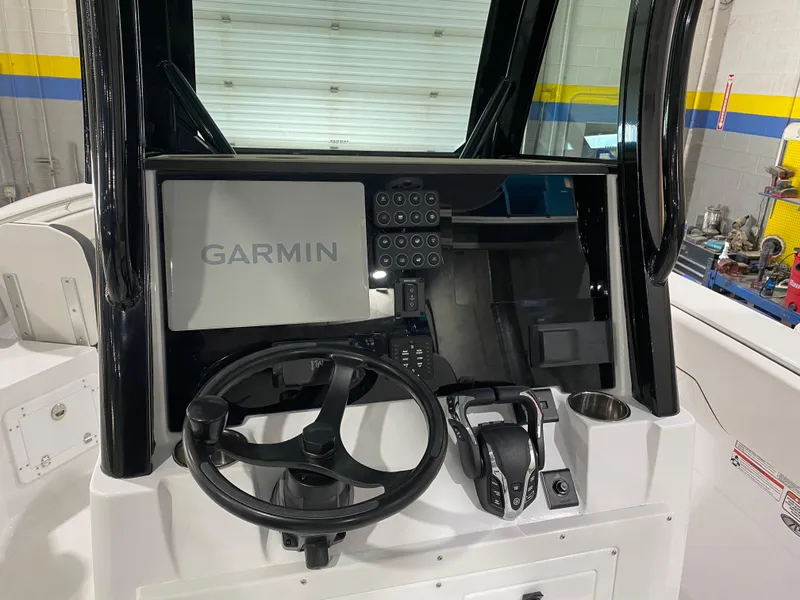 Slide: The Image of 2025 Stingray 253CC boat dashboard with Garmin navigation system and steering wheel. - 9
