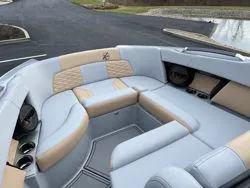 Slide: The Image of 2024 MasterCraft X26 interior seating with beige and gray upholstery. - 11