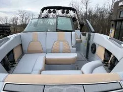 Slide: The Image of 2024 MasterCraft X26 boat interior with luxurious beige and gray seating. - 12