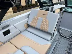 Slide: The Image of 2024 MasterCraft X26 boat interior with open hatch and visible fire extinguisher. - 14