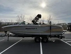 Slide: The Image of 2024 MasterCraft X26 boat on trailer in parking lot, overcast sky. - 4