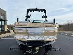 Slide: The Image of 2024 MasterCraft X26 boat, rear view, parked outdoors on a clear day. - 5