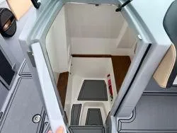 Slide: The Image of 2024 MasterCraft X26 interior with beige and gray seating, featuring cup holders and modern design. - 8