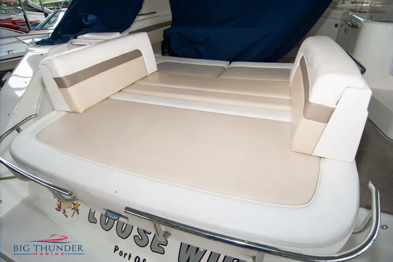 Slide: The Image of 2013 Sea Ray 540 Sundancer boat seating area with cushioned lounge. - 14