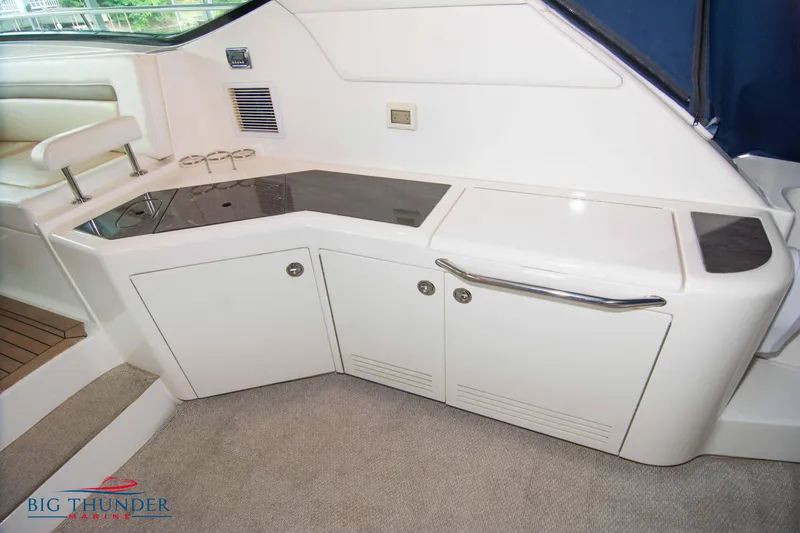 Slide: The Image of Interior of 2013 Sea Ray 540 Sundancer yacht with sleek white cabinetry. - 25
