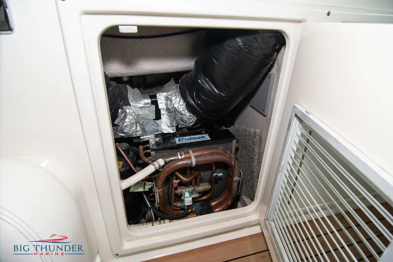 Slide: The Image of Engine compartment of 2013 Sea Ray 540 Sundancer with visible mechanical components. - 35