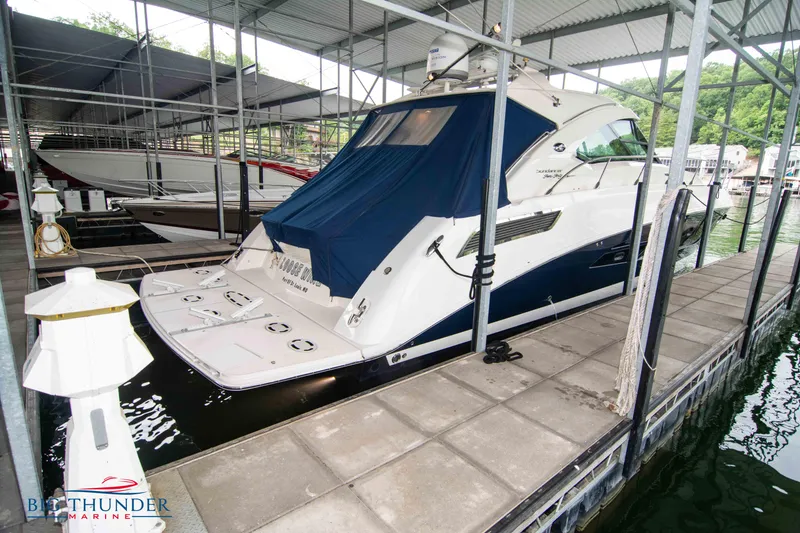 Slide: The Image of 2013 Sea Ray 540 Sundancer yacht docked in a marina under a covered slip. - 4