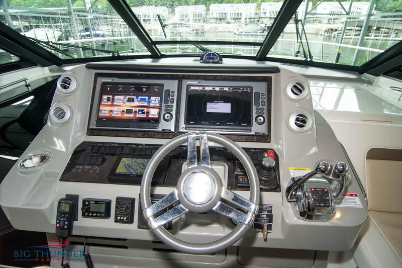 Slide: The Image of 2013 Sea Ray 540 Sundancer helm with dual navigation screens and controls. - 42