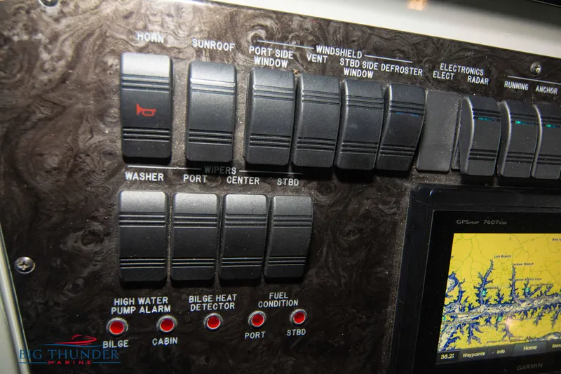 Slide: The Image of Control panel of a 2013 Sea Ray 540 Sundancer boat with various switches and indicators. - 49