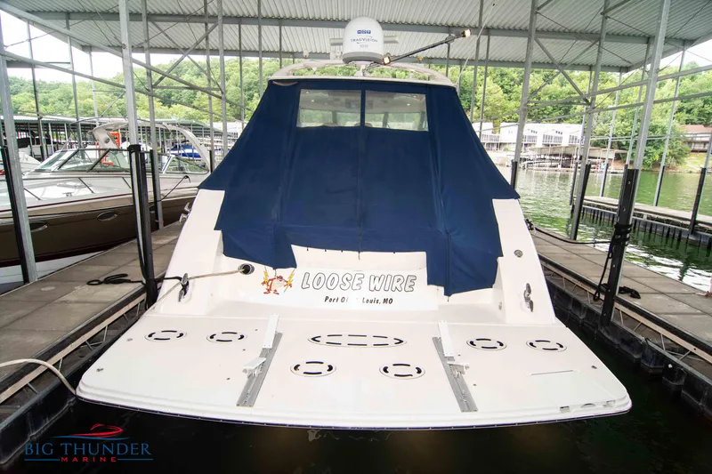 Slide: The Image of 2013 Sea Ray 540 Sundancer docked with blue cover, rear view. - 6