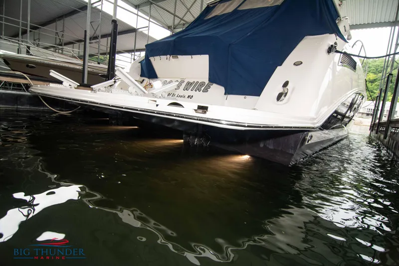 Slide: The Image of Sea Ray 540 Sundancer 2013 docked, covered, with water reflections and Big Thunder Marine logo. - 7