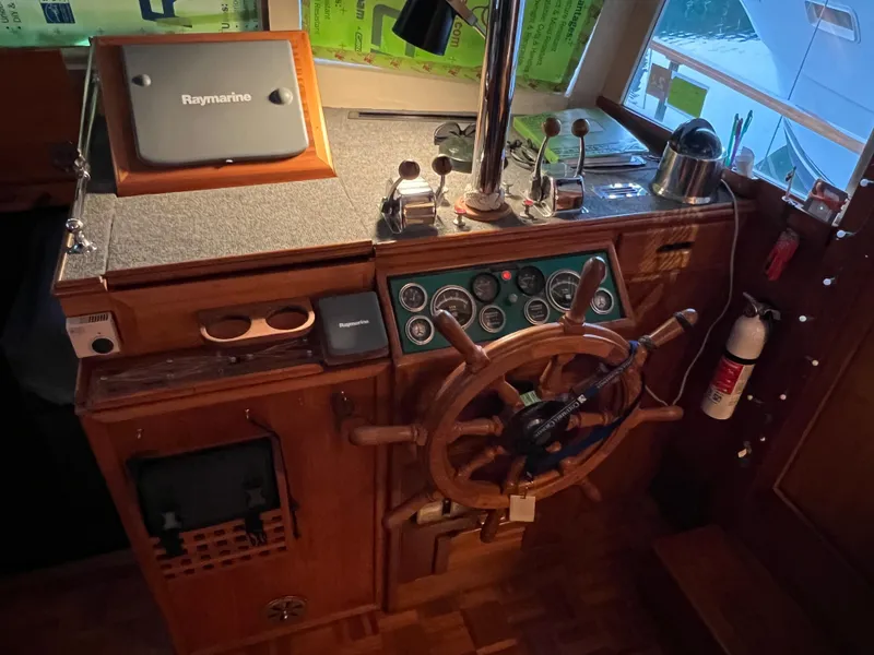 Slide: The Image of Helm of 1972 Grand Banks 42 Classic with wooden wheel and navigation instruments. - 12