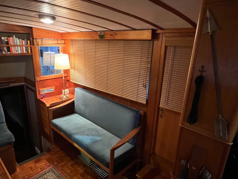 Slide: The Image of Interior of a 1972 Grand Banks 42 Classic yacht with wooden decor and cozy seating. - 13