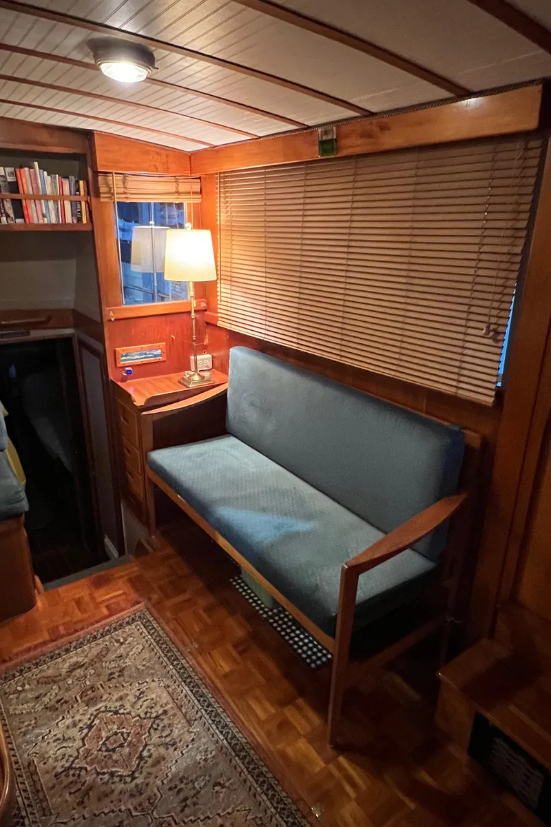Slide: The Image of Interior of a 1972 Grand Banks 42 Classic yacht with cozy seating and wooden decor. - 16