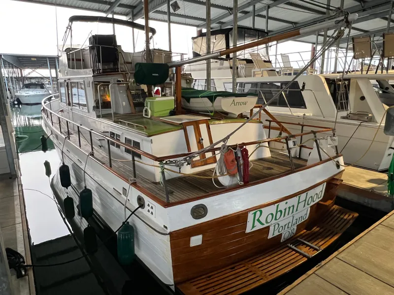 Slide: The Image of 1972 Grand Banks 42 Classic yacht docked in a marina, featuring wooden details and a covered deck. - 2