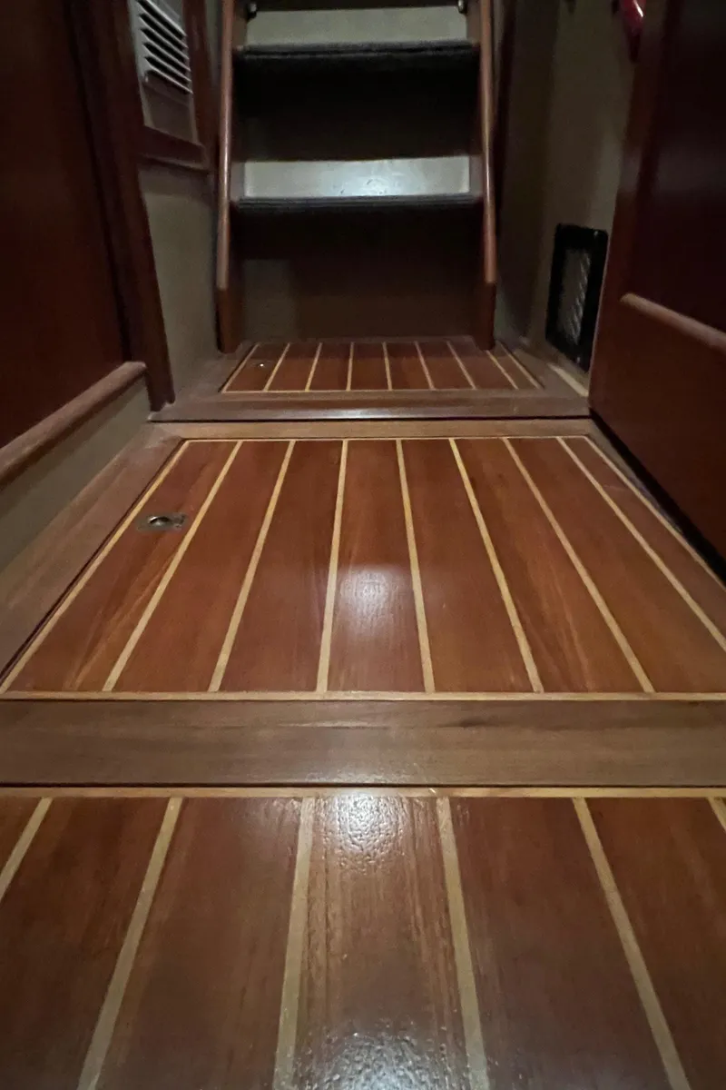 Slide: The Image of Interior view of 1972 Grand Banks 42 Classic with polished wooden flooring and stairs. - 22