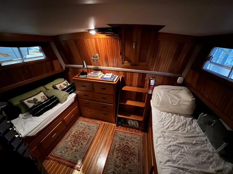 Slide: The Image of Cozy cabin interior of 1972 Grand Banks 42 Classic with wooden furnishings and twin beds. - 23