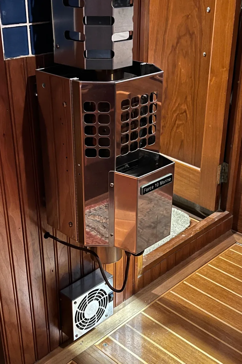 Slide: The Image of Wall-mounted heater inside a 1972 Grand Banks 42 Classic boat with wooden interior. - 28