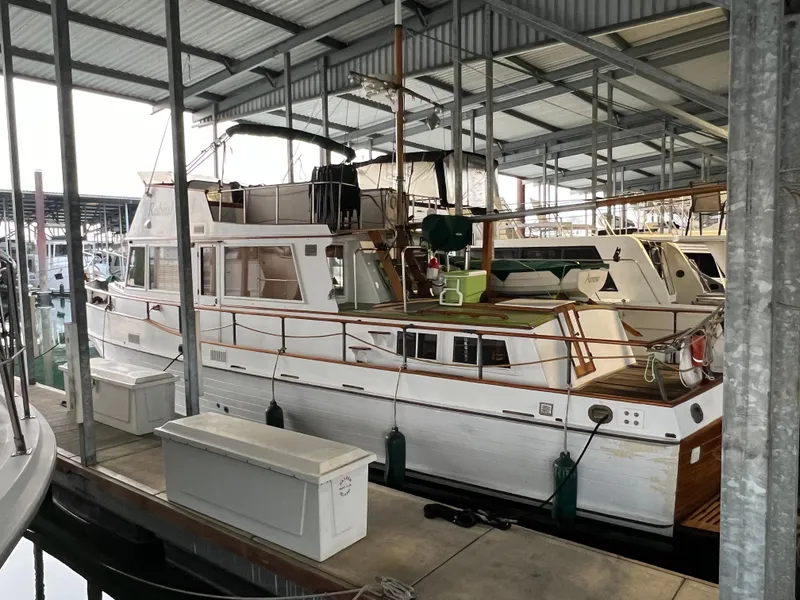 Slide: The Image of 1972 Grand Banks 42 Classic yacht docked in a covered marina. - 3