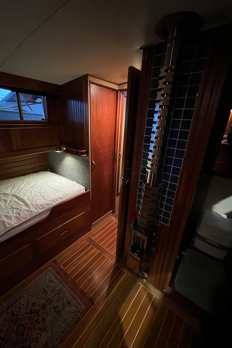 Slide: The Image of Cozy cabin interior of a 1972 Grand Banks 42 Classic yacht with wood paneling. - 30