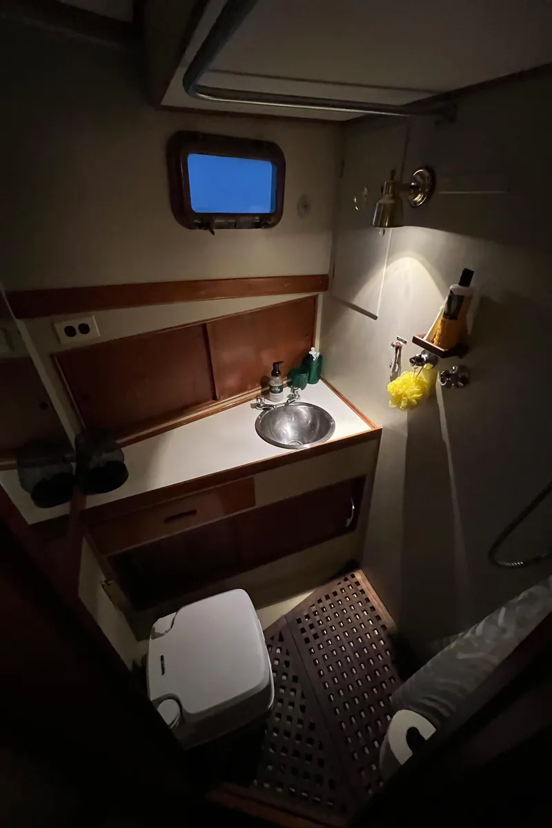 Slide: The Image of 1972 Grand Banks 42 Classic yacht bathroom with sink, window, and shower amenities. - 32