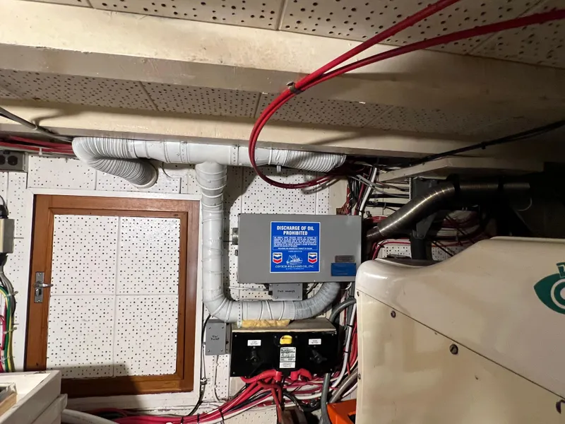 Slide: The Image of Engine room of a 1972 Grand Banks 42 Classic boat with wiring and ventilation. - 34