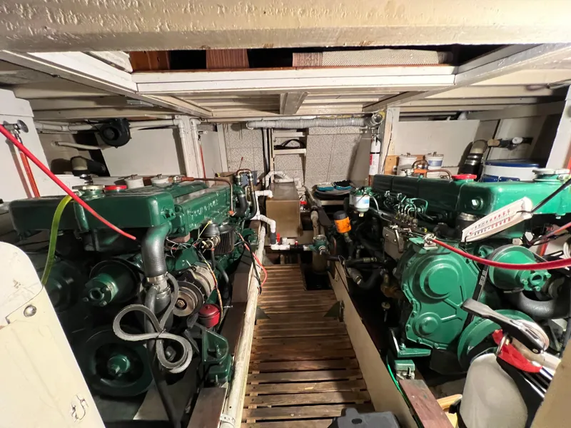 Slide: The Image of Engine room of a 1972 Grand Banks 42 Classic boat, featuring dual green engines. - 37