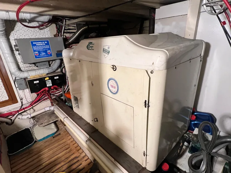 Slide: The Image of Engine room of a 1972 Grand Banks 42 Classic yacht, featuring equipment and wiring. - 38