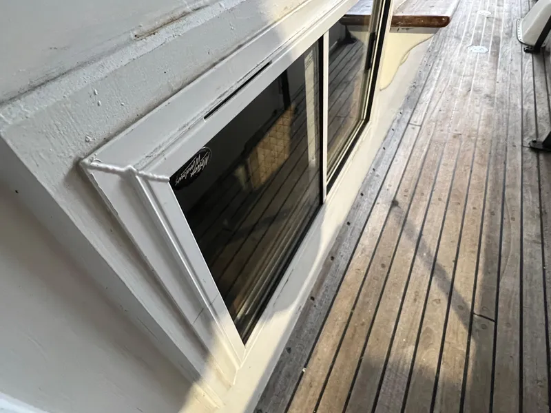 Slide: The Image of 1972 Grand Banks 42 Classic boat deck with wooden flooring and window detail. - 4