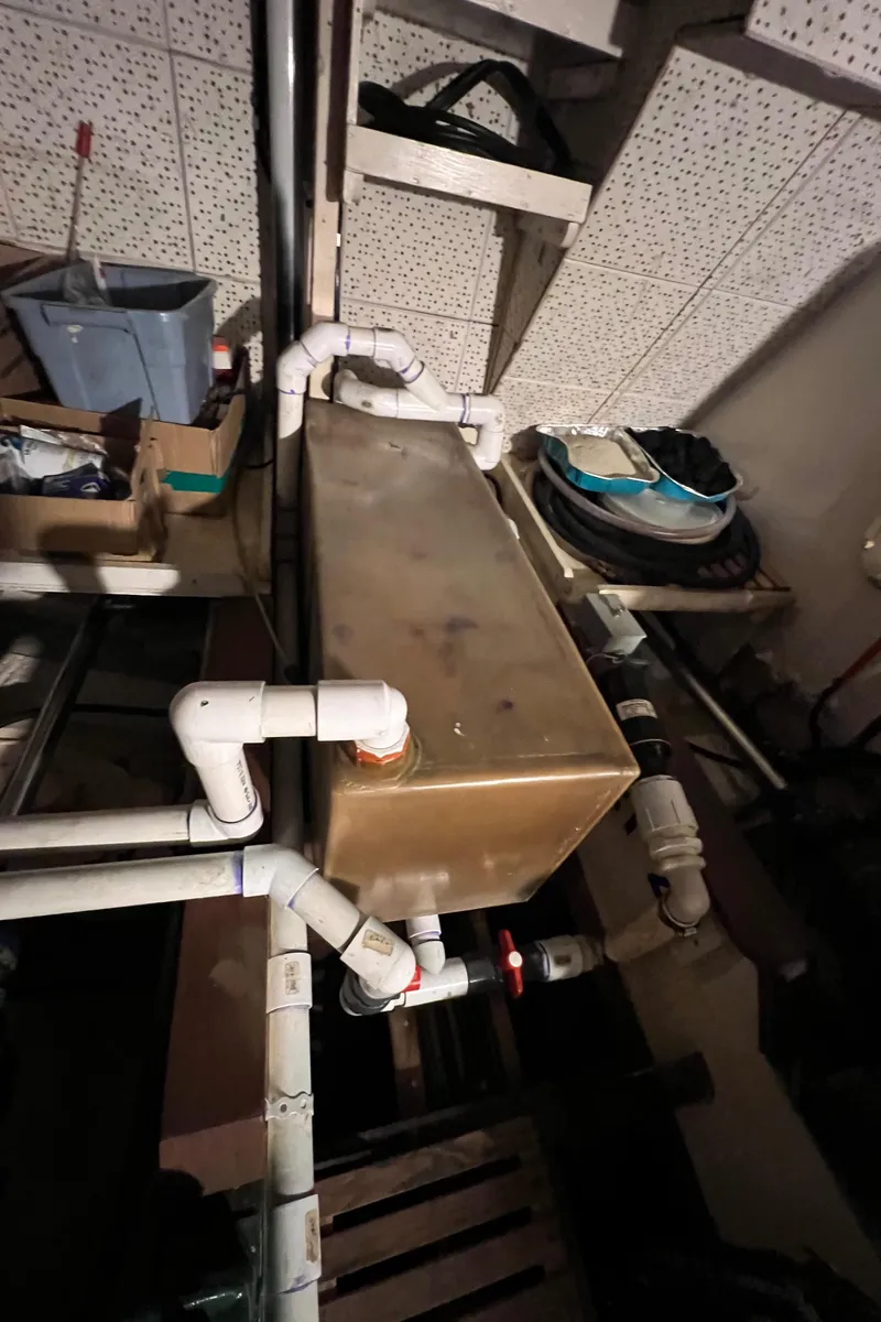 Slide: The Image of Engine room of a 1972 Grand Banks 42 Classic with visible piping and equipment. - 42