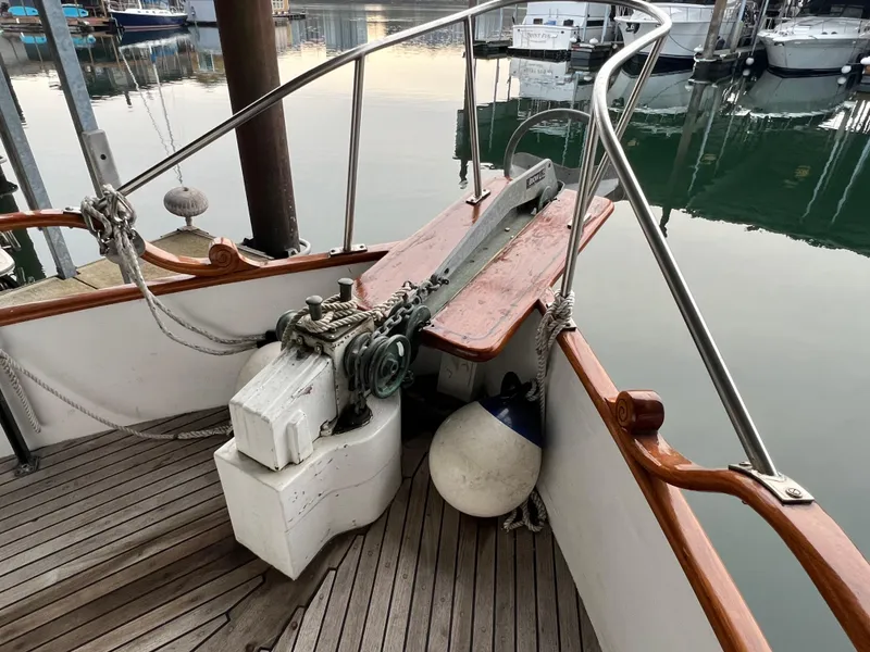 Slide: The Image of 1972 Grand Banks 42 Classic boat deck with anchor winch and railing at marina. - 5