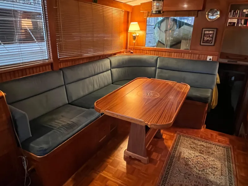 Slide: The Image of Interior of a 1972 Grand Banks 42 Classic yacht with cozy seating and wooden table. - 7
