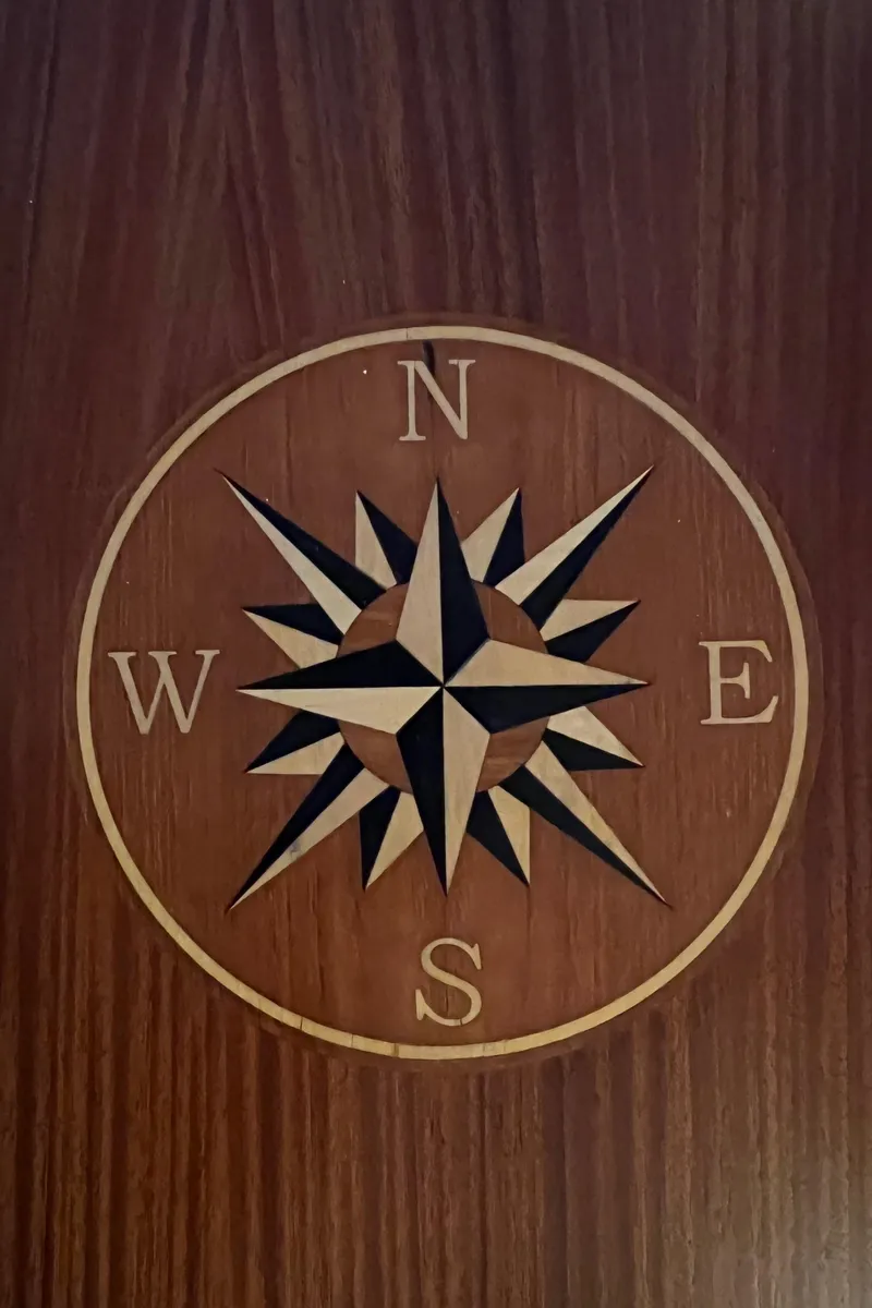 Slide: The Image of Compass rose design on wood panel, Grand Banks 42 Classic, 1972. - 8