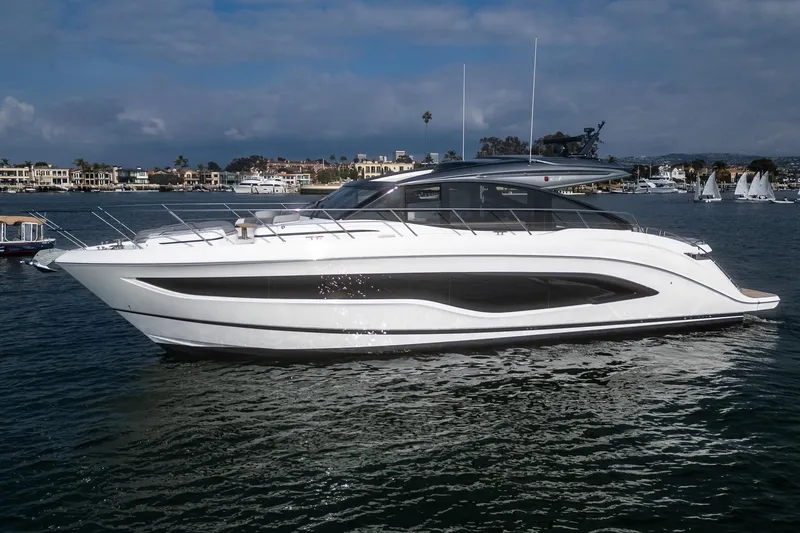 Slide: The Image of 2025 Princess V55 yacht cruising on a serene waterway. - 0