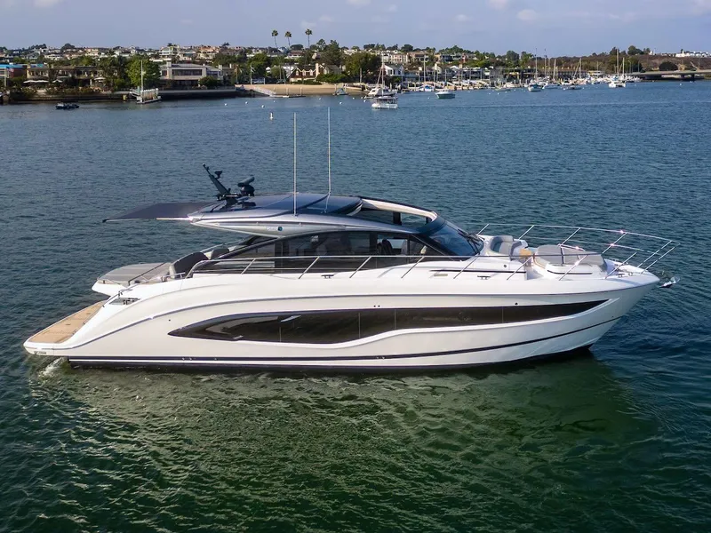 Slide: The Image of 2025 Princess V55 yacht on serene water, luxury design, coastal backdrop. - 1