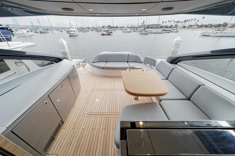 Slide: The Image of Luxurious 2025 Princess V55 yacht interior with sleek seating and elegant wooden deck. - 13