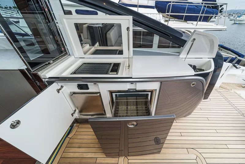 Slide: The Image of Luxury yacht Princess V55 2025 outdoor kitchen with grill and storage on teak deck. - 14