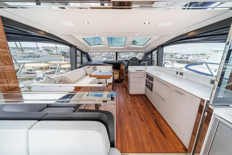 Slide: The Image of Luxurious 2025 Princess V55 yacht interior with modern kitchen and seating area. - 17