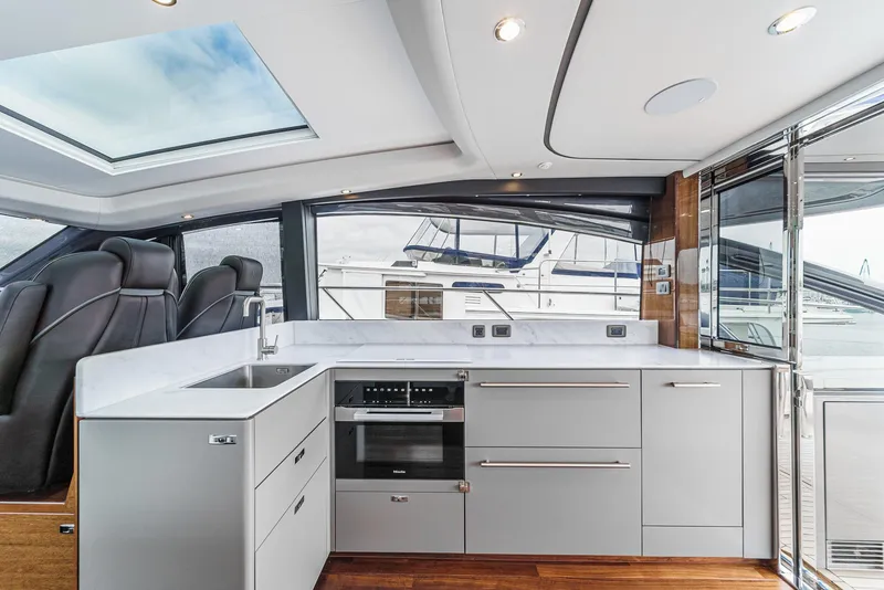 Slide: The Image of Luxurious 2025 Princess V55 yacht interior with modern kitchen and sleek design. - 18