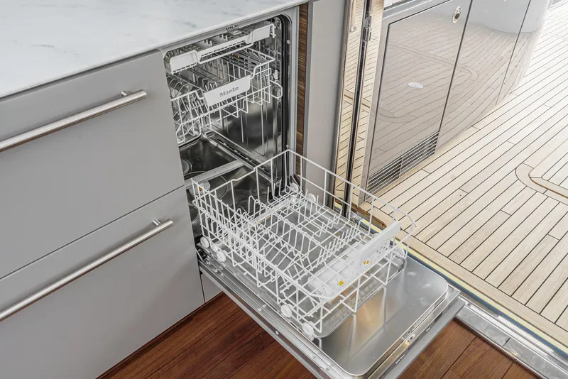 Slide: The Image of Open dishwasher on Princess V55 yacht, 2025 model, with modern kitchen design. - 21