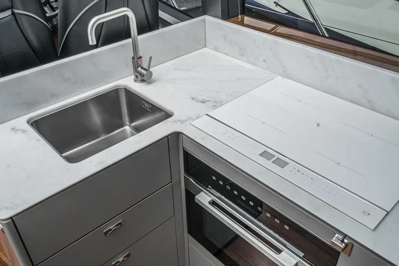 Slide: The Image of Modern kitchen area in 2025 Princess V55 yacht with sleek sink and stove. - 22