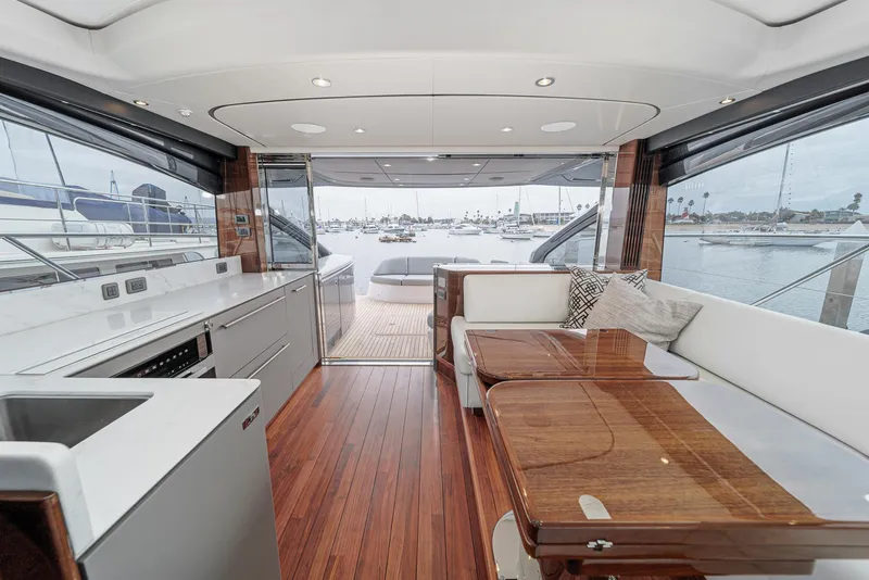 Slide: The Image of Luxurious 2025 Princess V55 yacht interior with modern kitchen and seating area. - 24