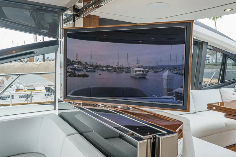 Slide: The Image of Luxurious 2025 Princess V55 yacht interior with large TV and marina view. - 27