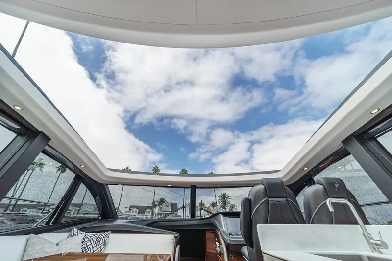 Slide: The Image of Interior view of 2025 Princess V55 yacht with panoramic sunroof and luxurious seating. - 29